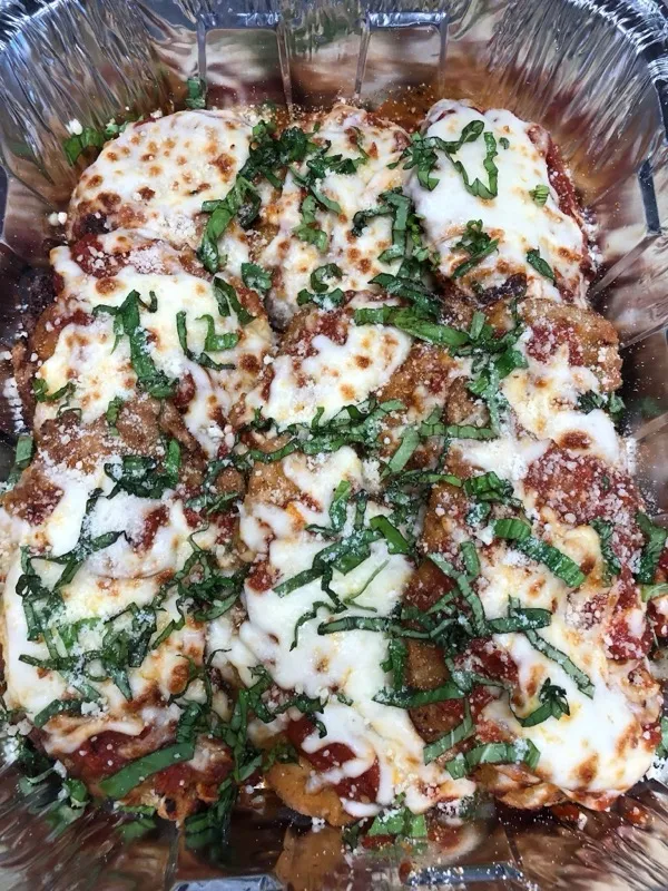 Fresh baked chicken parmesan with melted mozzarella and basil, made by Deag's On The Go